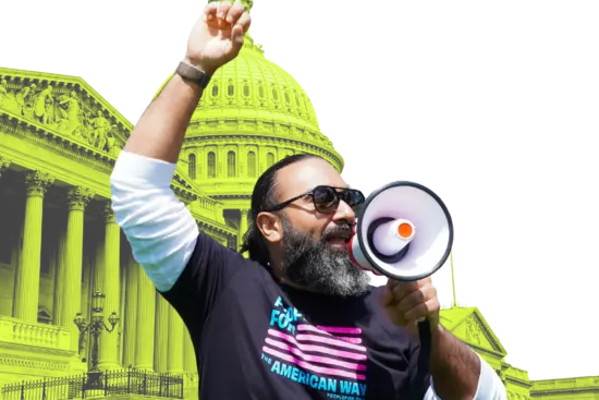 activist carries a bullhorn in front of the capitol. 