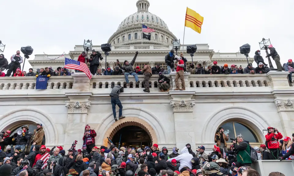 Insurrectionists climb the U.S Capitol building on January 6th