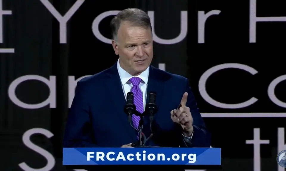 Center for Judicial Renewal's Phillip Jauregui speaks on stage at Pray Vote Stand conference at lectern that has placard reading "FRCAction.org"