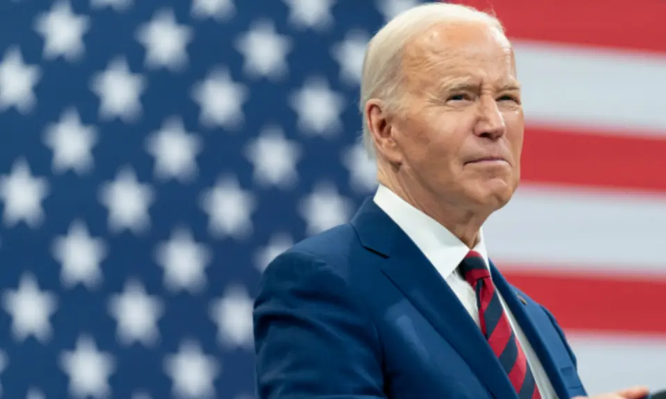 President Biden in front of an American flag.