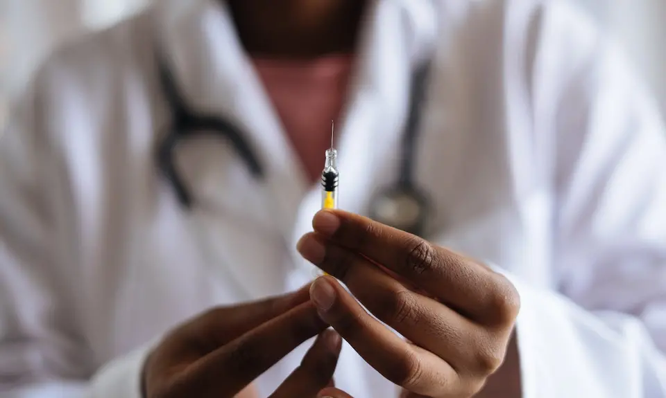 Doctor preparing a vaccine