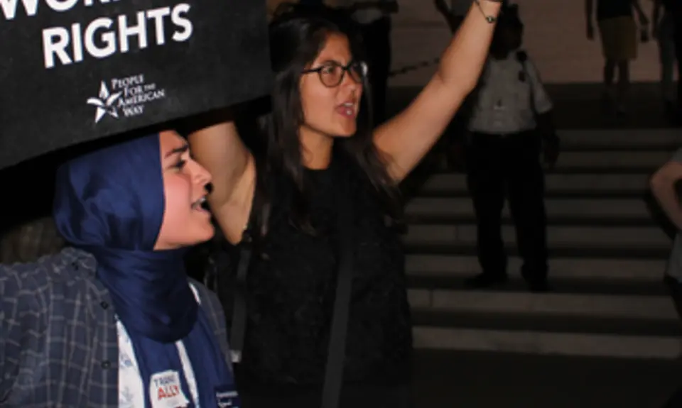 Two women hold signs saying "Save SCOTUS" and "Save workers' rights" outside the Supreme Court with the title Confirmed Judges, Confirmed Fears