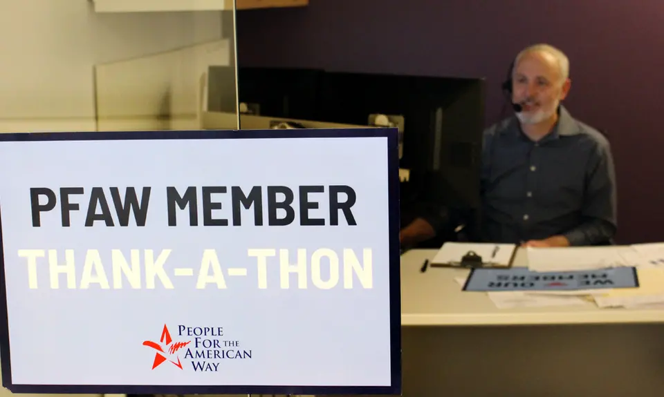 A Sign that says "PFAW Member Thank-a-Thon" in front of a PFAW staff member's desk