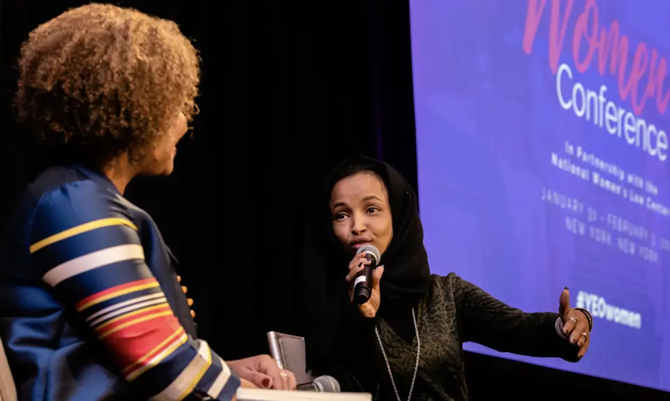 Two women speak at the YEO Women's Conference