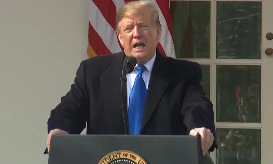 Donald Trump stands at a podium