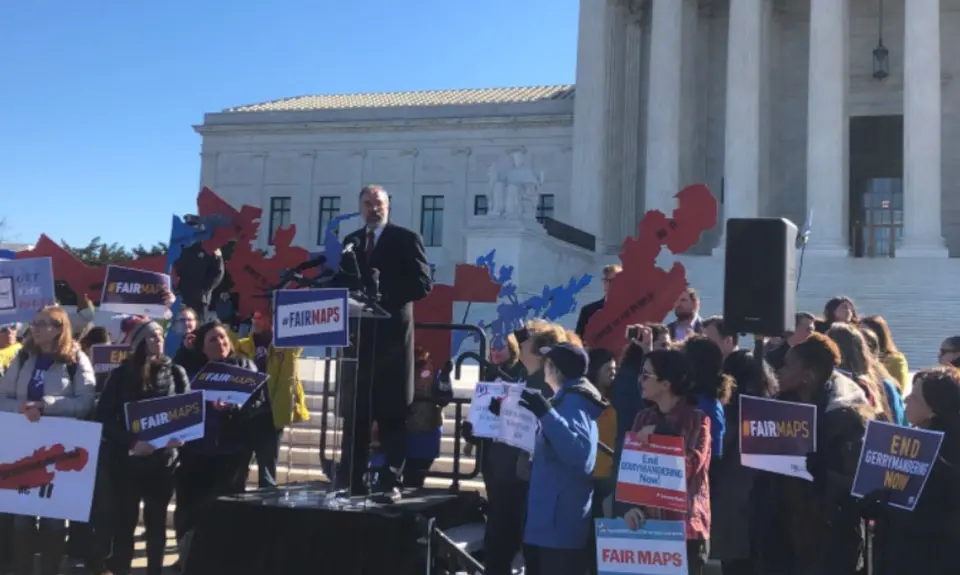 People hold signs at a voting rally