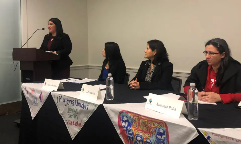 A group of four women speak at a panel