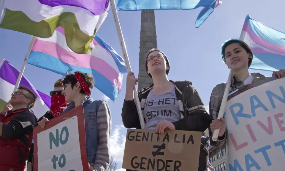 Crowd in Asheville, North Carolina holds signs, waves symbolic flags, and protests the North Carolina's HB2 law that restricts rights to those who are gay or transgender