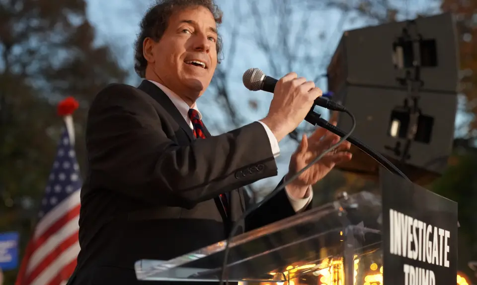 Jamie Raskin stands at a podium and gives a speech