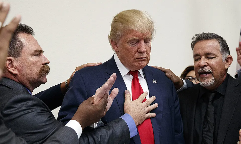 Men pray with Donald Trump