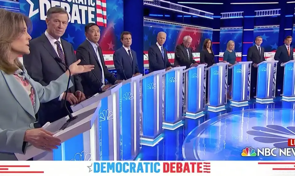 Candidates stand behind podiums on stage at a Democratic debate