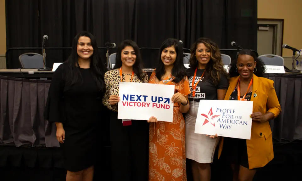 Lizet Ocampo, Sammi Brown, Eloria Diaz, Anna Eskamani, and Summer Lee hold PFAW signs at the 2019 Netroots Nation conference