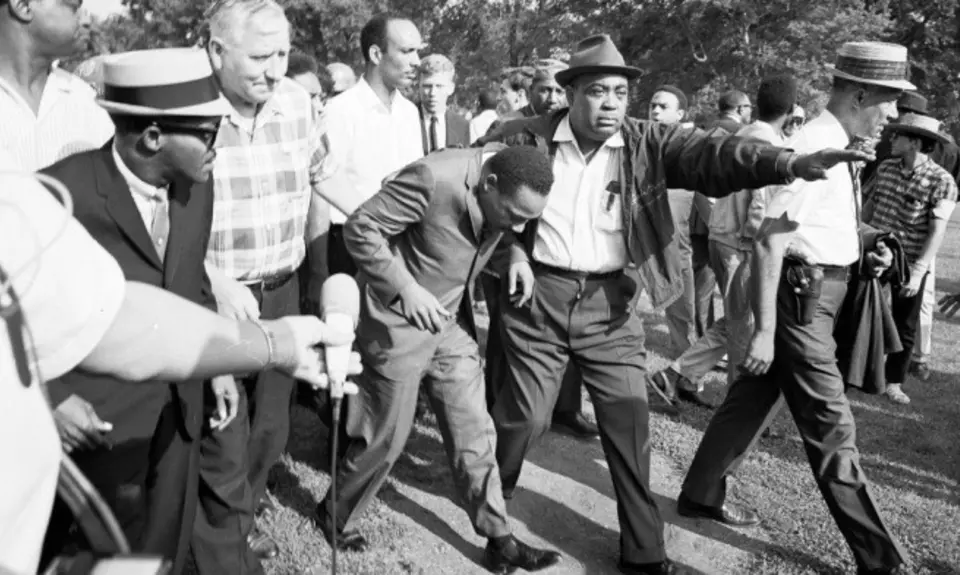 Civil rights protesters, including Martin Luther King, Jr., march toward a realtor's office in 1966