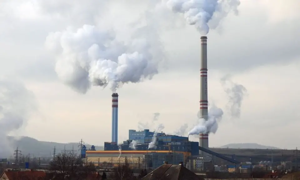 factory with chimneys emitting smoke into the sky