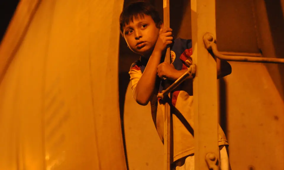 An 11-year-old Honduran riding the freight train they call La Bestia.