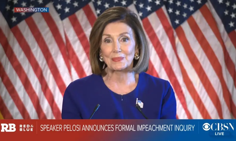 A screenshot of CBS News showing Nancy Pelosi standing in front of a line of American flags with the text "Speaker Pelosi announces formal impeachment inquiry."