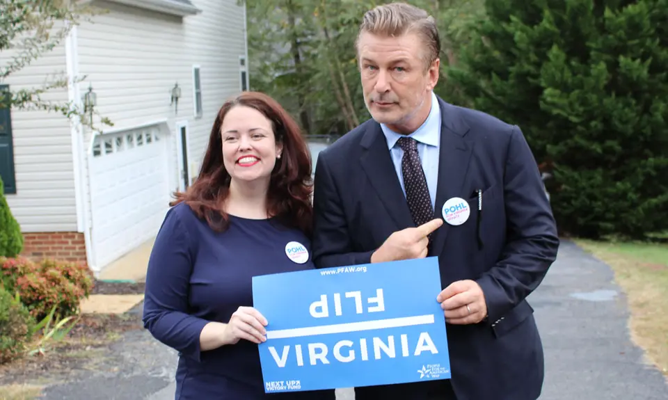 Actor Alec Baldwin and Senate Candidate Amanda Pohl holding a sign that says "Flip Virginia"