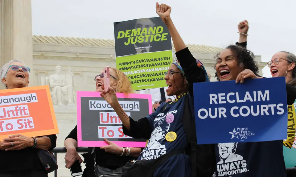 Activists hold signs outside the Supreme Court saying "Kavanaugh: Unfit to Sit," "Reclaim our courts," and "Demand justice: Impeach Kavanaugh"