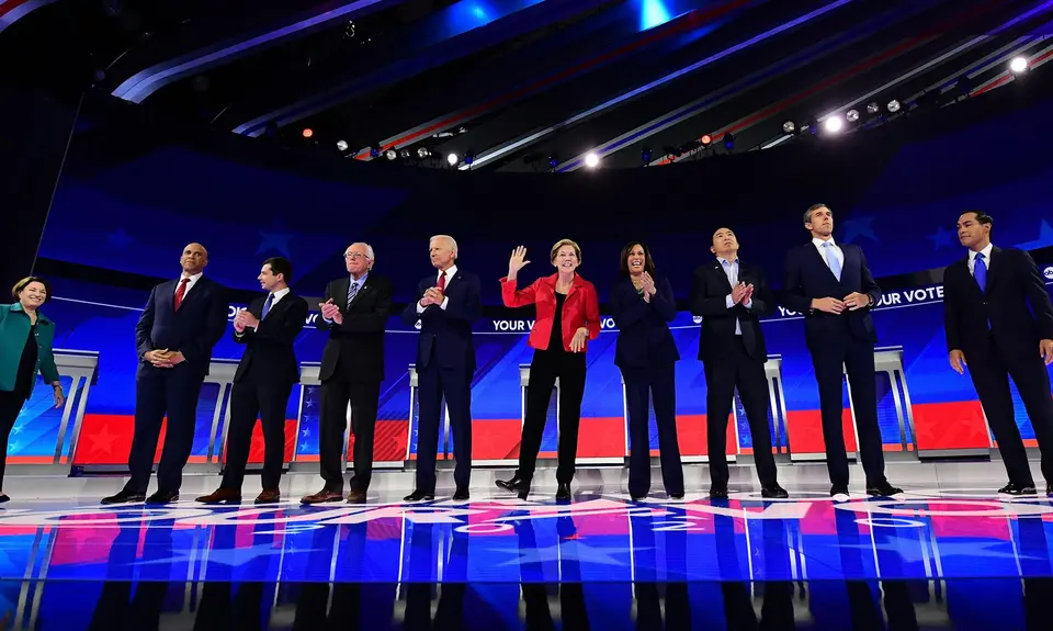 Democratic presidential candidates stand on a stage during a debate in 2019.