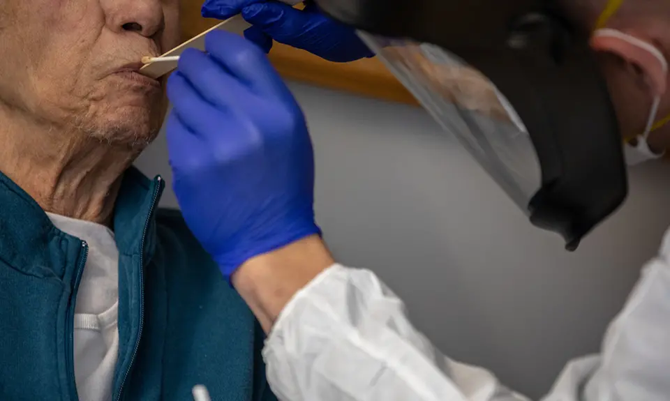 A doctor taking someone's temperature