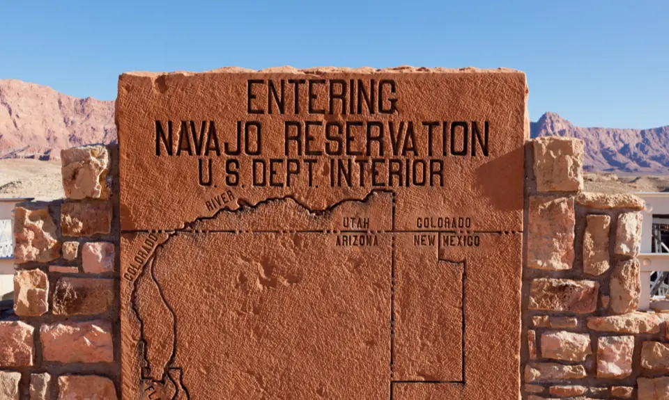 At Grand Canyon National Park, a rock sign displays a map area of the Navajo Nation, one of many Native American tribes that are battling higher rates of the coronavirus.