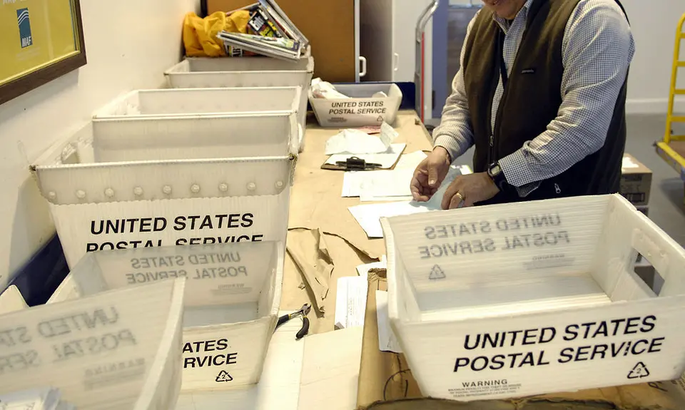 United States Postal Service boxes on table.