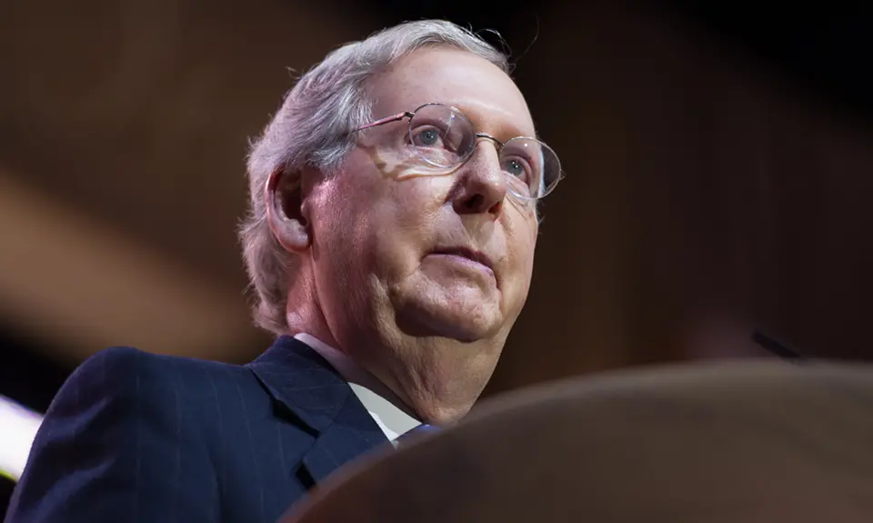 Mitch McConnell stands at a podium.