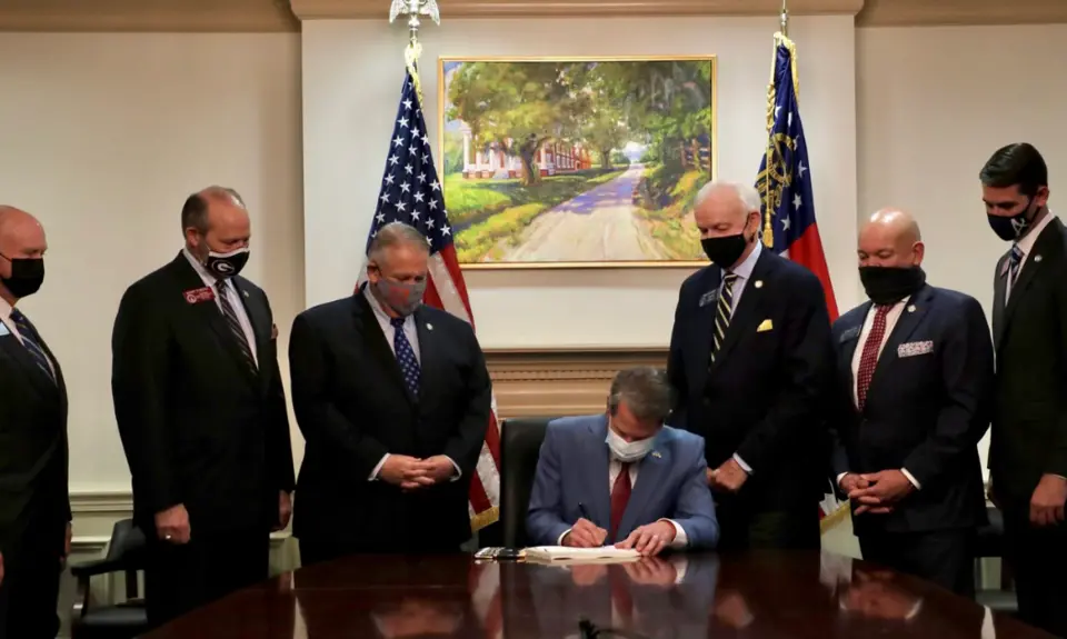 GA Governor Brian Kemp signing voter suppression bill SB202 into law on March 25, 2021