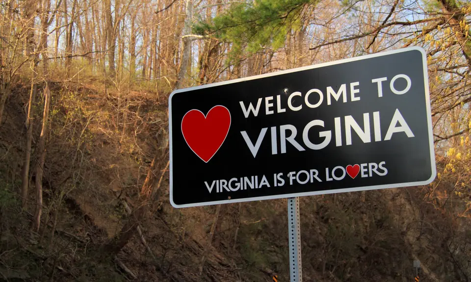 A street sign that reads "Welcome to Virginia, Virginia is for lovers"