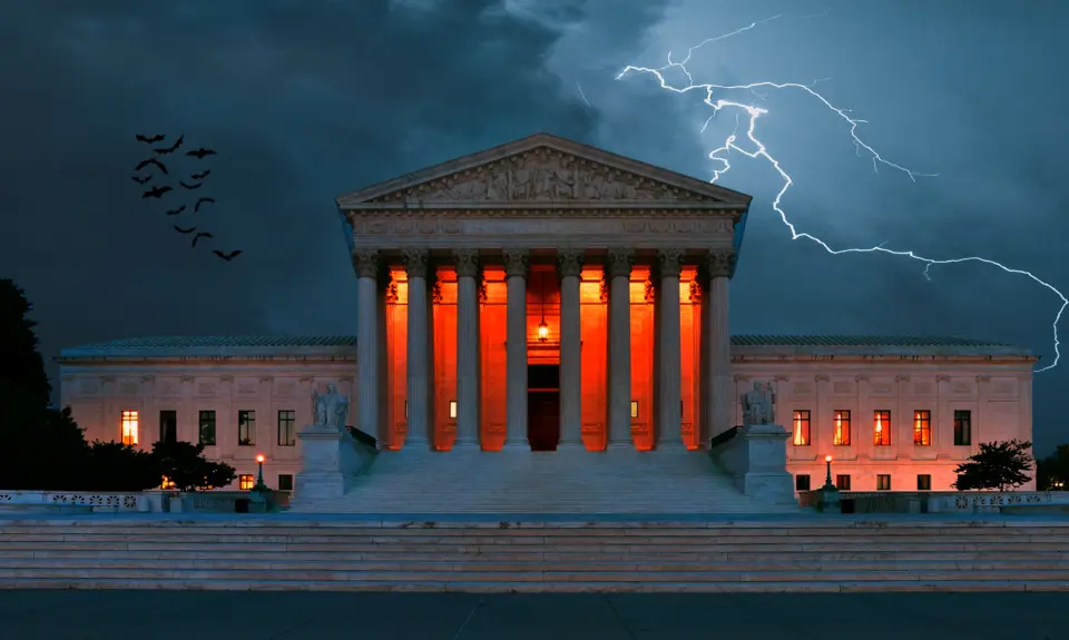 A scary image of the Supreme Court building with orange lights, lightning, and bats