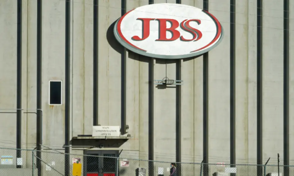 A sign on a wall that says "JBS"