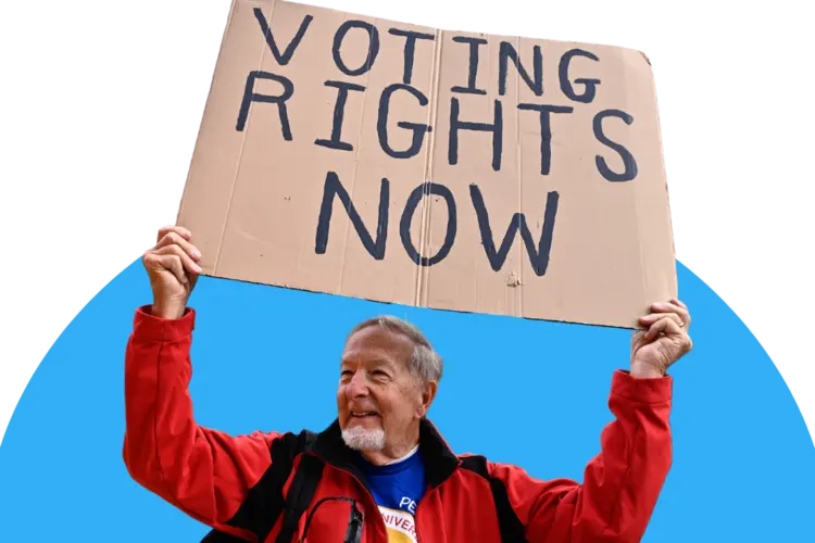 Rallygoer with a sign that reads "Voting Rights Now"