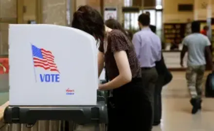 a person is voting at a polling booth