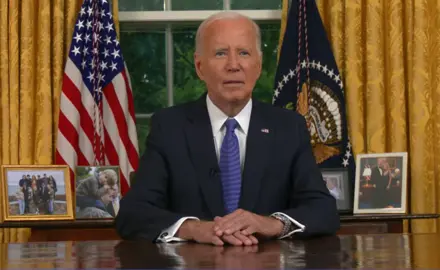 President Joe Biden sitting at his desk in the Oval Office.