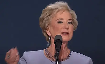 Image of Linda McMahon gesturing with her right hand while speaking into microphone on stage at the 2024 Republican National Convention