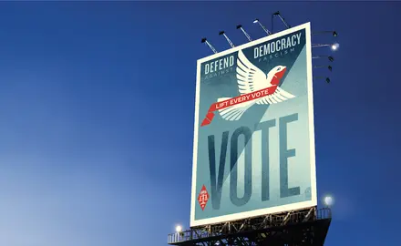 Billboard with art urging people to vote to defend democracy