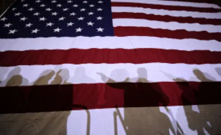 Flag with shadows of people in front of it.