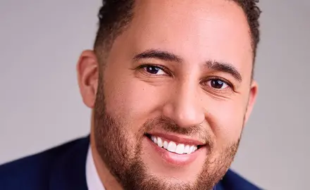 Headshot of Svante Myrick wearing dark blue suit.