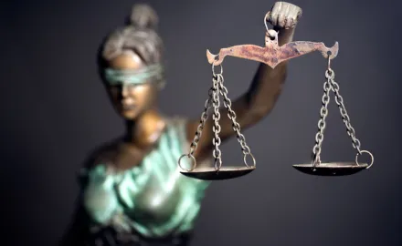 A photo of a statue of lady Justice holding scales.