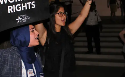 Two women hold signs saying "Save SCOTUS" and "Save workers' rights" outside the Supreme Court with the title Confirmed Judges, Confirmed Fears