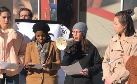 A woman speaks into a megaphone