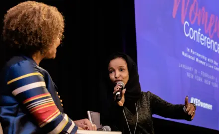 Two women speak at the YEO Women's Conference