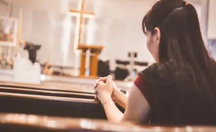 A woman prays in a church