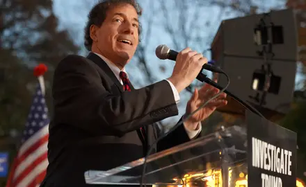 Jamie Raskin stands at a podium and gives a speech