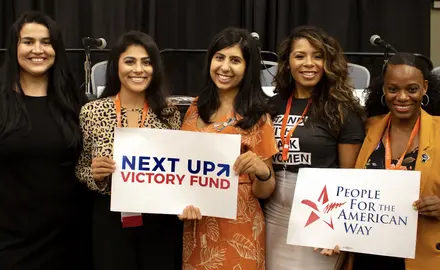 Lizet Ocampo, Sammi Brown, Eloria Diaz, Anna Eskamani, and Summer Lee hold PFAW signs at the 2019 Netroots Nation conference