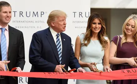 Donald Trump with his wife and children cutting the ribbon on Trump hotel.