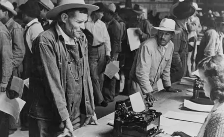 Mexican farm workers line up as they are registered to work in the US through the Bracero program.