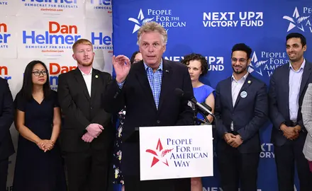 Former VA Gov. Terry McAuliffe at the speaker's podium at PFAW's Next Up 2019 Virginia kickoff event.