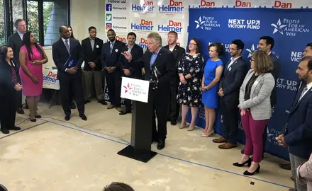 Former VA Gov. Terry McAuliffe at the speaker's podium at PFAW's Next Up 2019 Virginia kickoff event.