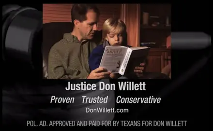 A screenshot from Don Willett's 2012 campaign ad that shows him reading the Bible with a child.